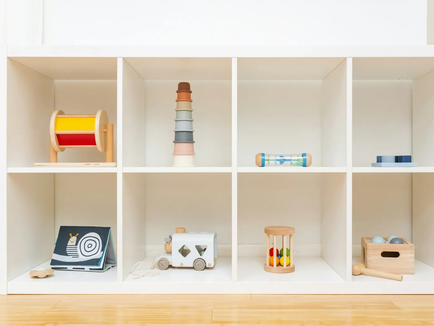 Wooden learning materials arranged in order on open low shelving
